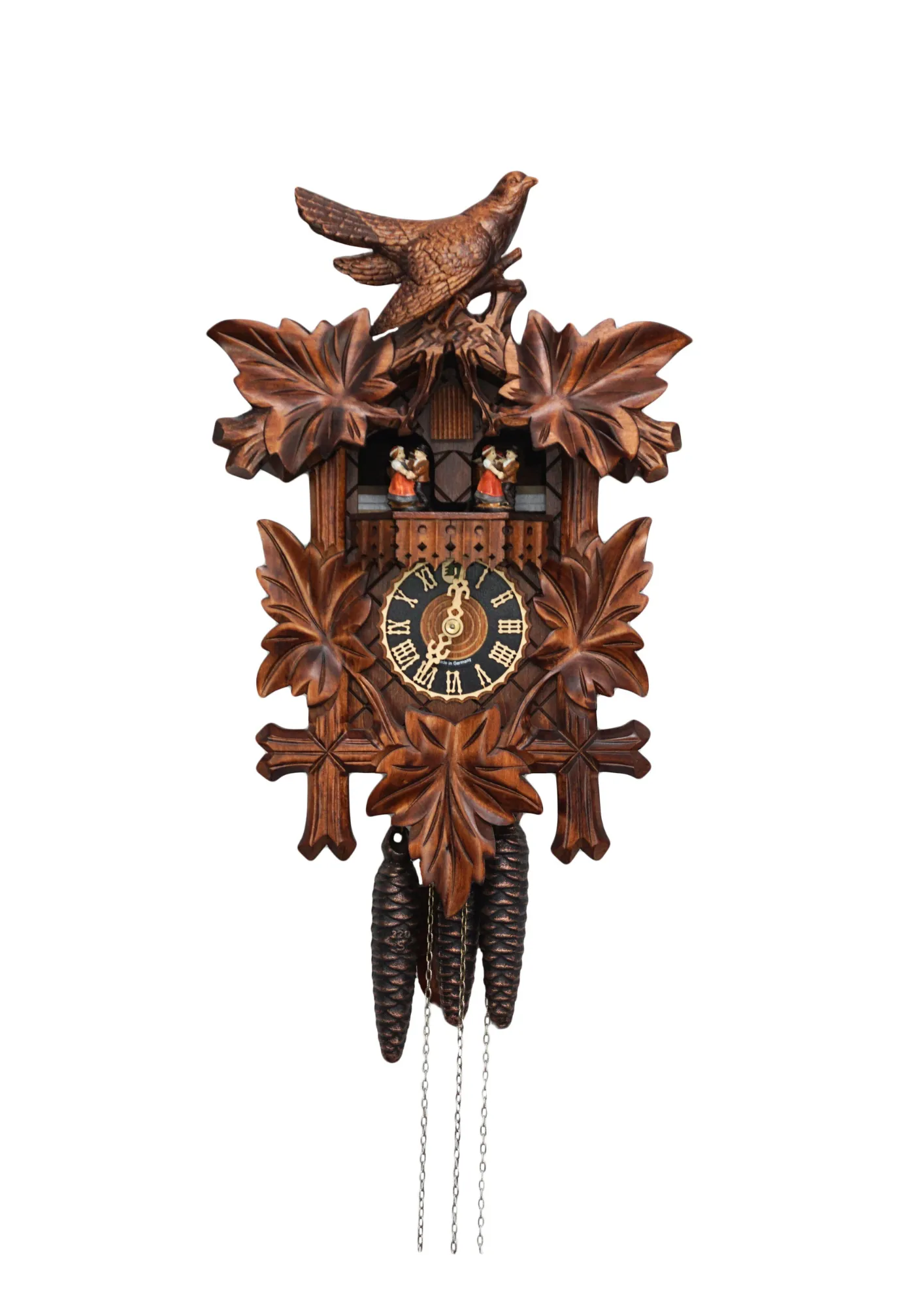 Traditional stlye hard carved mechanical black forest cuckoo clock decorated with a carving of a cuckoo bird, plays music and has dancers made by Hönes
