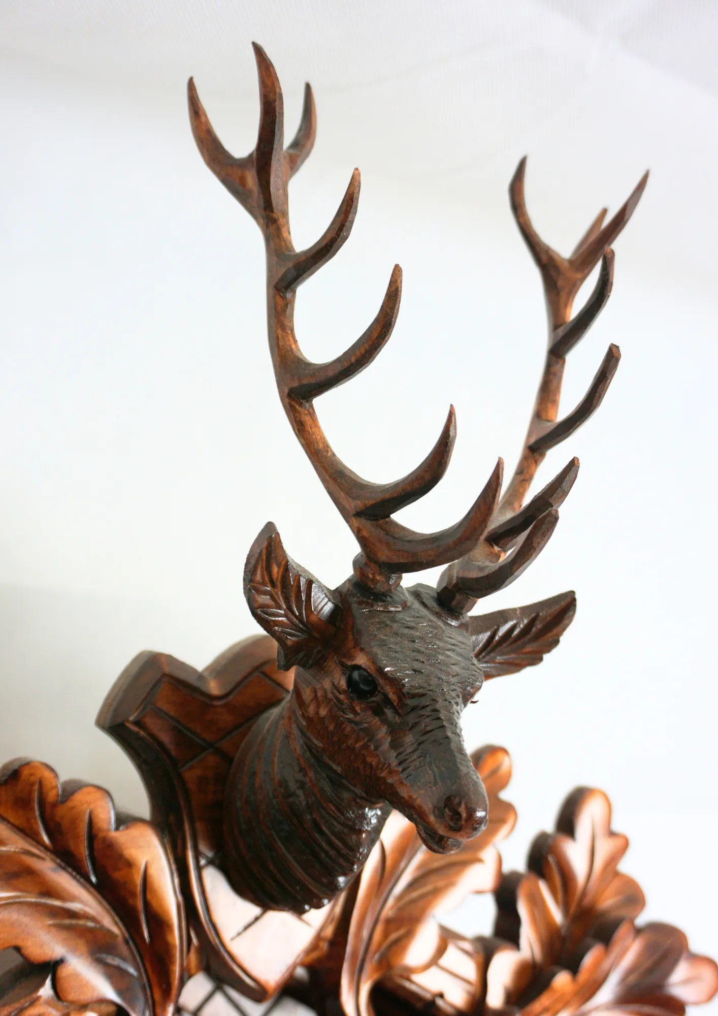 Cuckoo Clock Hunter Clock 8 Day Movement (3) Hand carved authentic mechanical brown black forest cuckoo clock in a hunter theme. Precisely carved deer head is decorating the top while there is a hunter and a falcon figure on the sides of the clock. The clocks dial is wraped with a hunting horn while