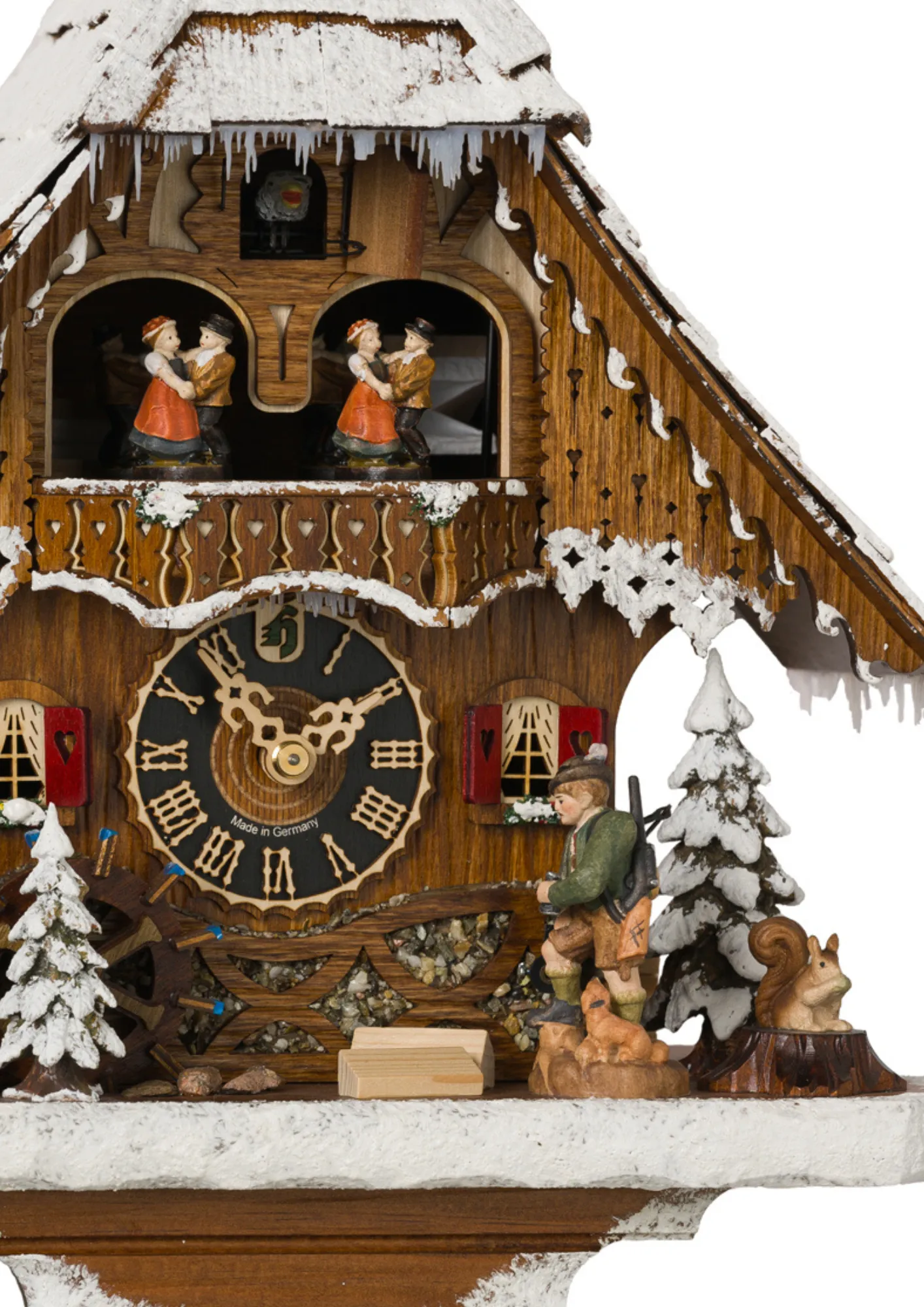 Cuckoo Clock Snow Chalet 1 Day Movement with Music (2) Middle size mechanical black forest chalet cuckoo clock covered in snow with music, hunter figure lifts its binoculars looking thowards the deer, dancers and water wheel turn as the music plays