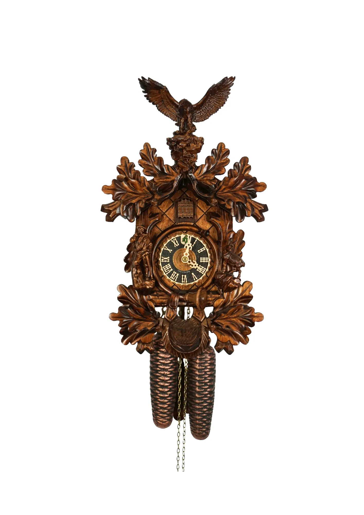 beautifully carved black forest brown mechanical cuckoo clock with an eagle on top of its crown, also decorated with a detailed figure of hunter and mountin goat. The dial is wraped with a hunting horn and beneath it hunting bag is hanging