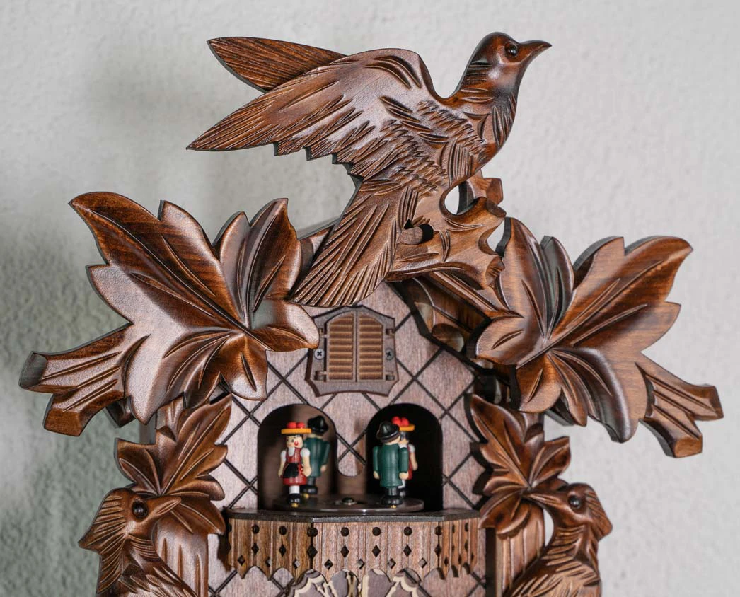 Cuckoo Clock Traditional Style, Three Birds Battery (5) traditional style carved cuckoo clock with ivy leaves and three birds decorating the clock, plays music and dancers turn made by Trenkle Uhren