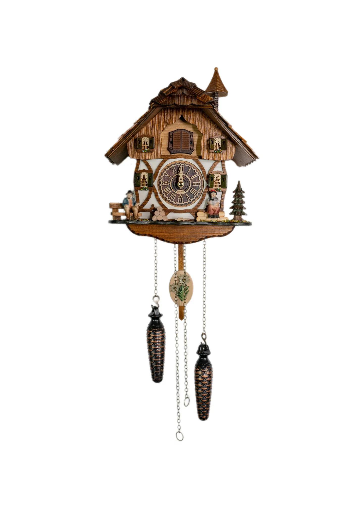 Battery cuckoo clock with a black forest couple in front of the chalet house plays music made by Trenkle Uhren