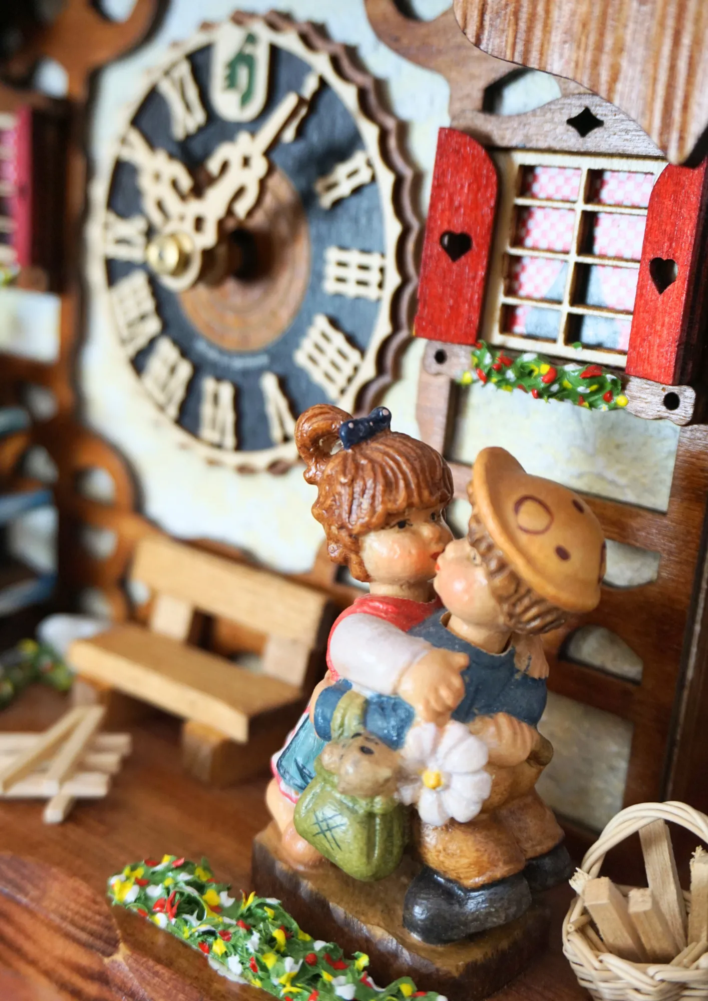 Chalet shingle roof mechanical black forest cuckoo clock with presice attention to detail. The kids are turning their heads and kissing, water wheel turns and the dancers are dancing as the music is playing