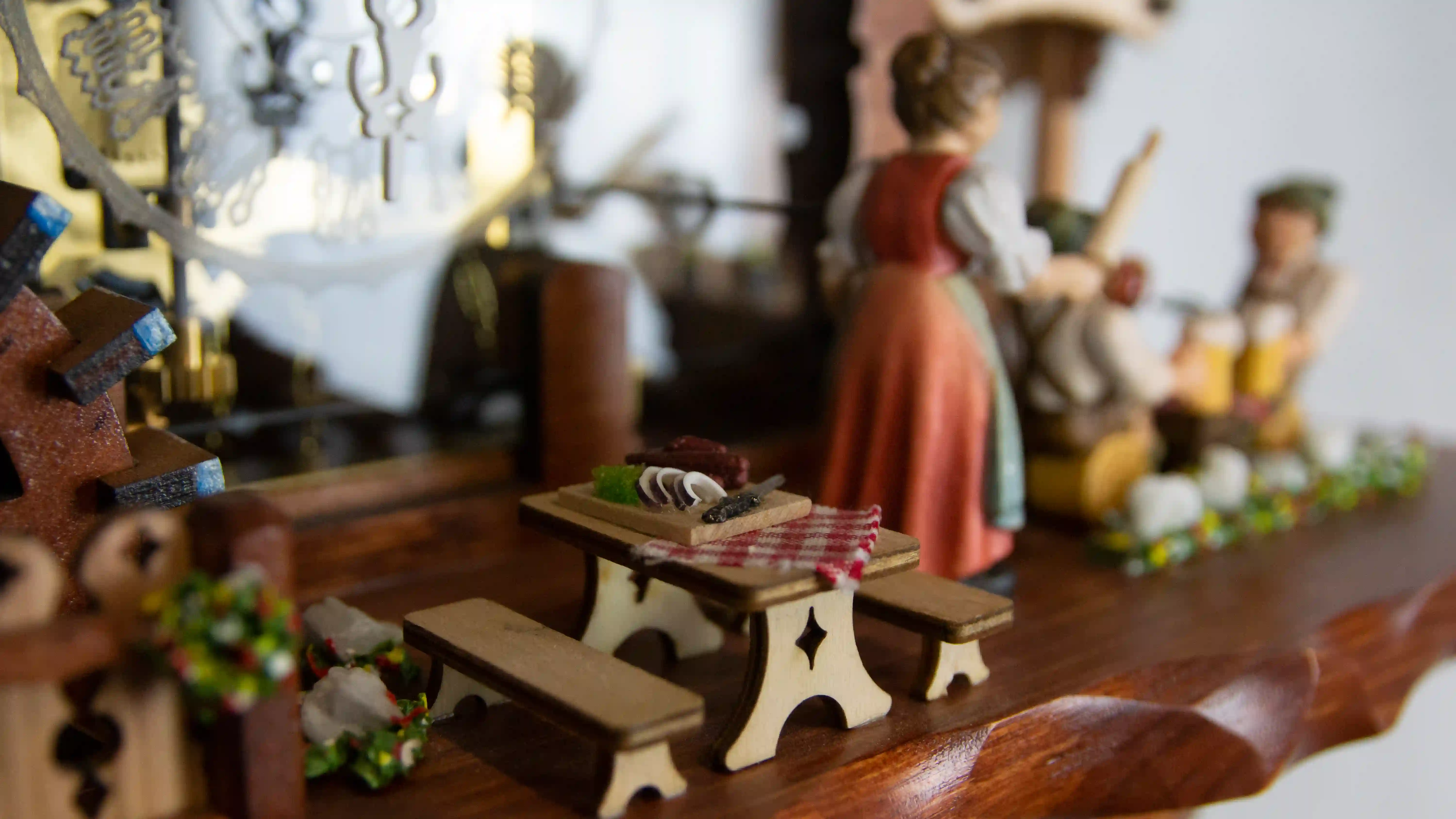 Authentic mechanical large coloful black forest cuckoo clock with transparent plexiglass and visible inside movement. It displays two beer drinkers in the beer garden and the lady with a rolling pin. As the music is playing dancers dance, water wheel turn