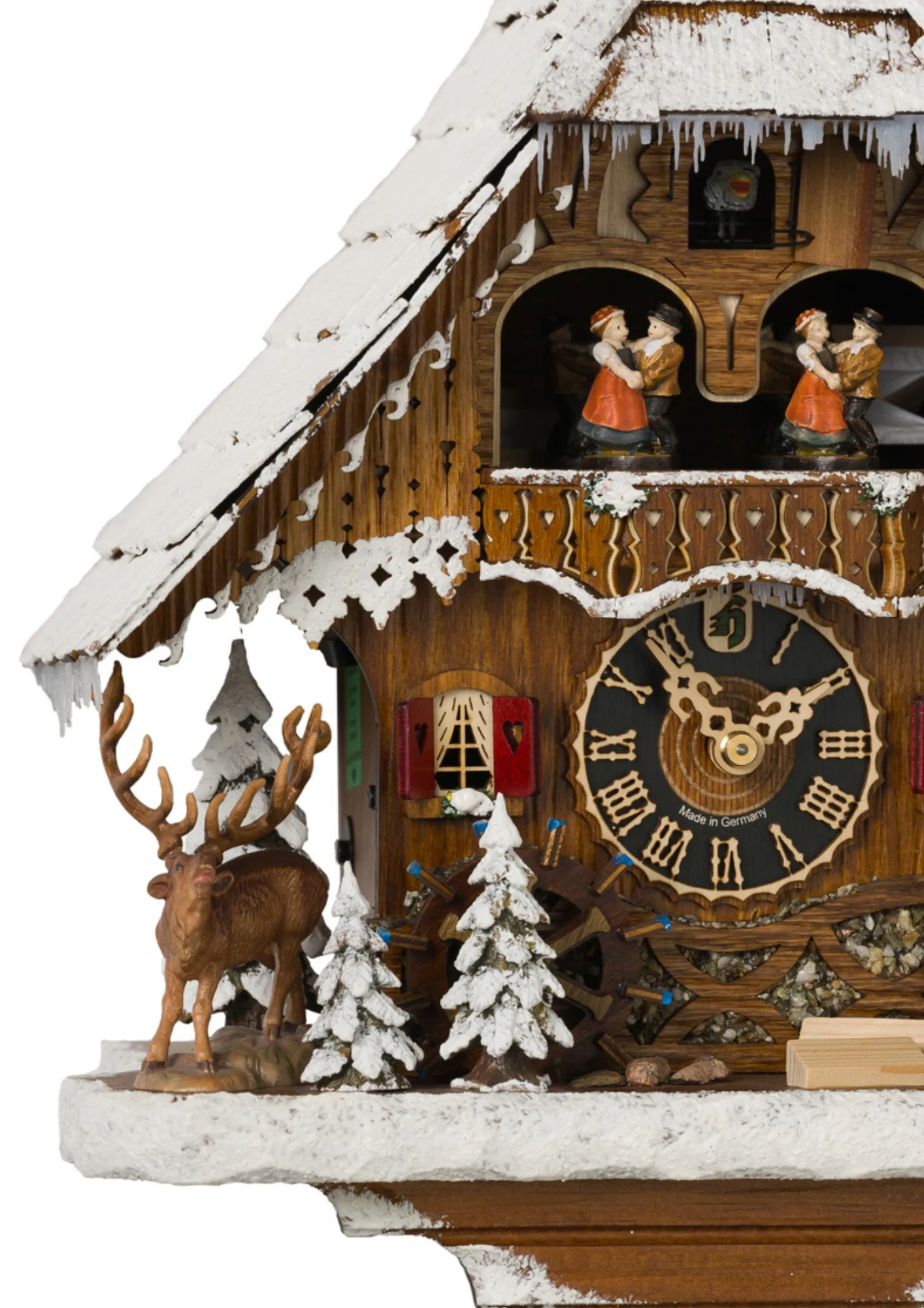 Cuckoo Clock Snow Chalet 1 Day Movement with Music (3) Middle size mechanical black forest chalet cuckoo clock covered in snow with music, hunter figure lifts its binoculars looking thowards the deer, dancers and water wheel turn as the music plays